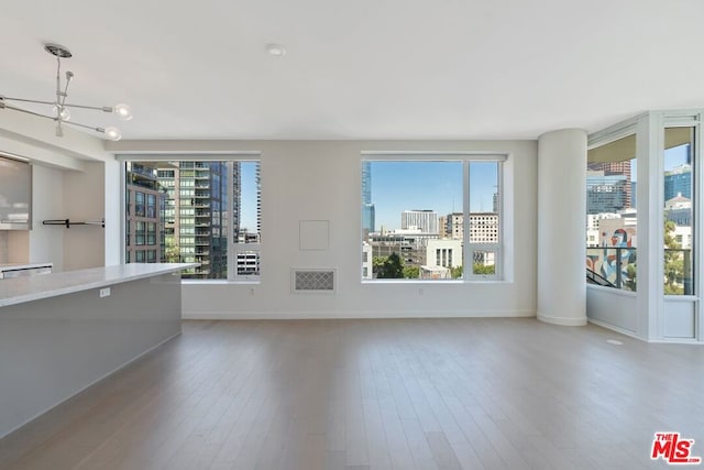 unfurnished living room with wood-type flooring