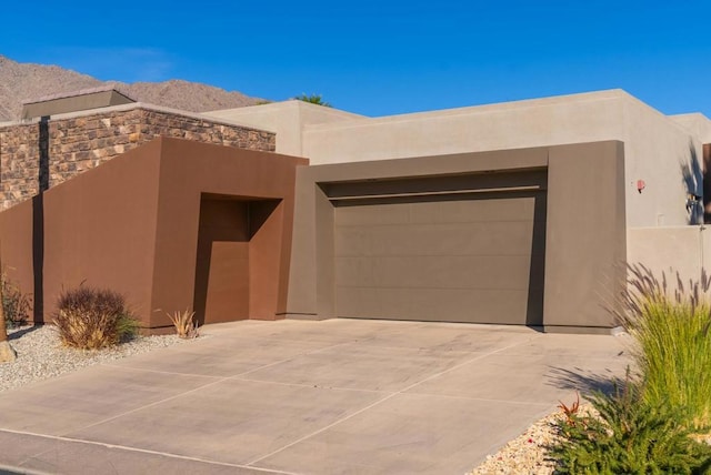 adobe home featuring a garage and a mountain view