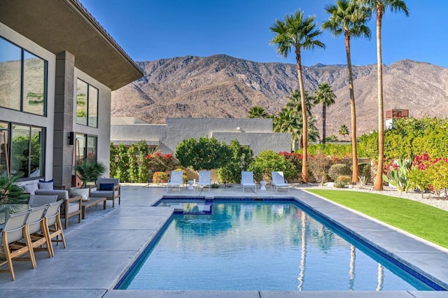 view of swimming pool featuring a mountain view and a patio