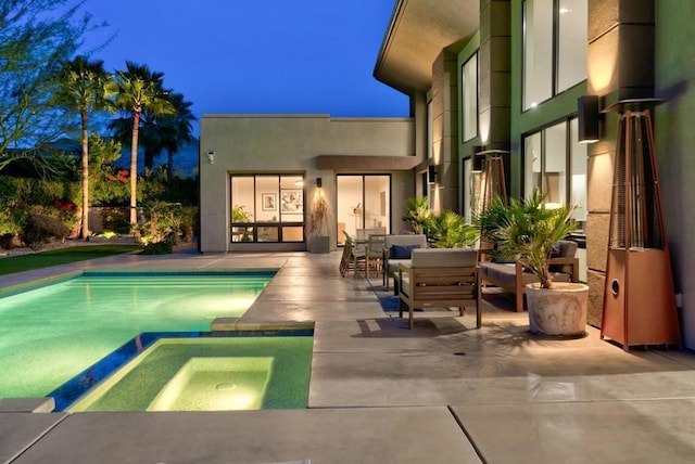 view of pool with an outdoor living space, an in ground hot tub, and a patio area