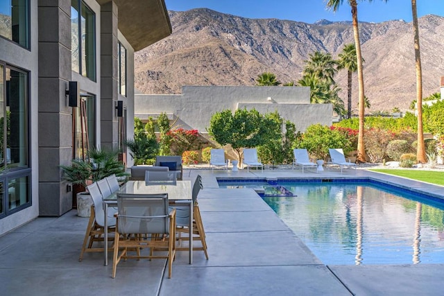 view of pool featuring a mountain view and a patio area