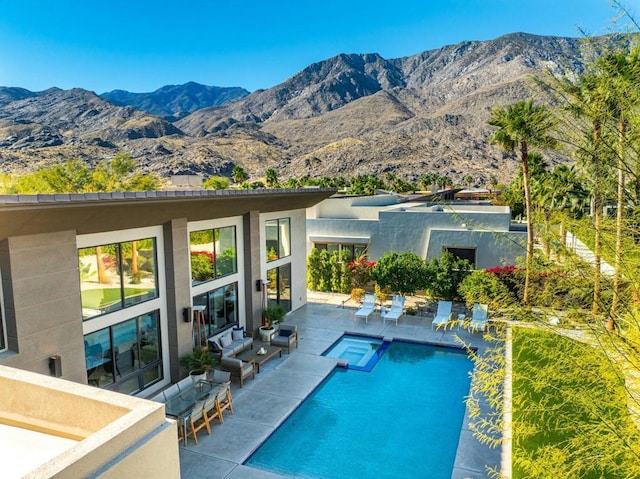 view of pool with a mountain view and a patio