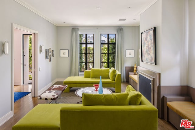 living room with dark hardwood / wood-style floors and ornamental molding