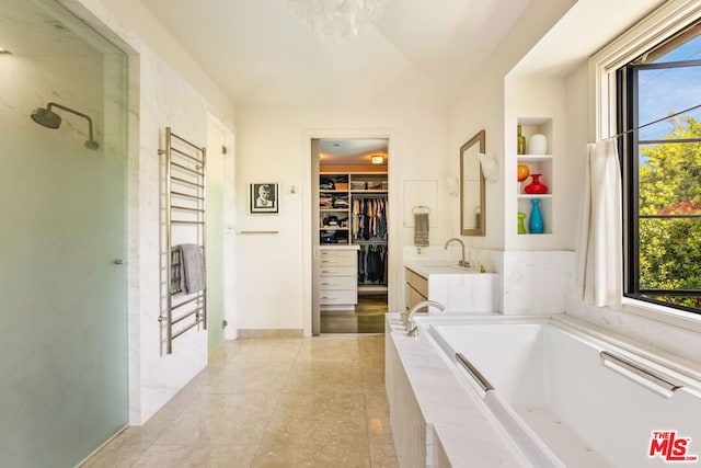 bathroom with tile patterned floors, vanity, and independent shower and bath