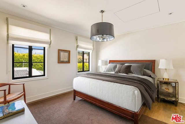 bedroom with crown molding and multiple windows