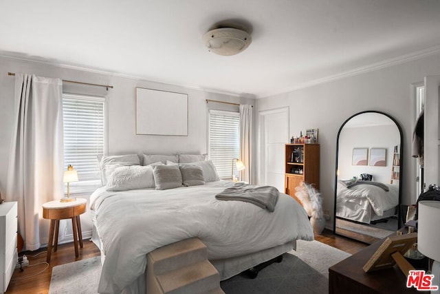 bedroom featuring hardwood / wood-style floors and crown molding