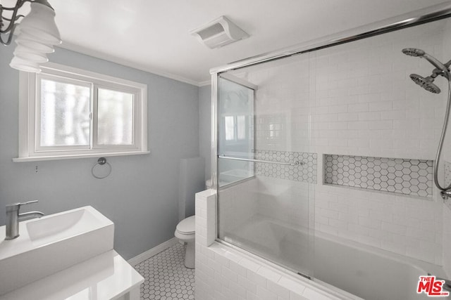 full bathroom with tile patterned floors, vanity, toilet, and combined bath / shower with glass door