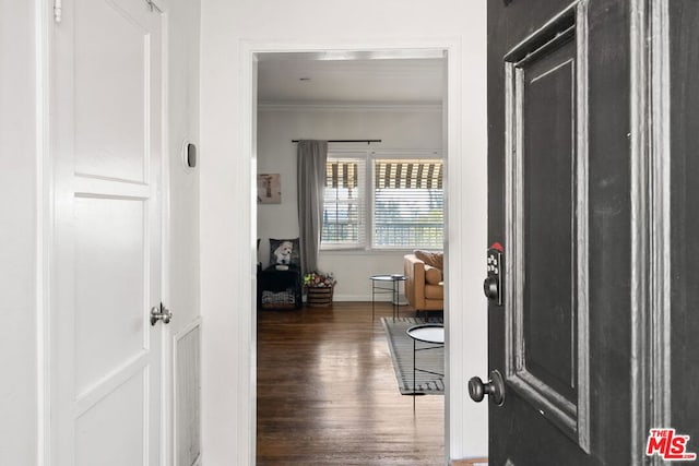 hall featuring crown molding and dark hardwood / wood-style floors