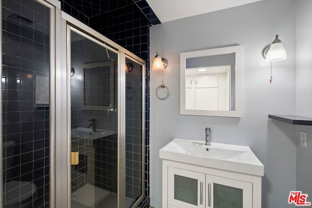 bathroom with vanity and an enclosed shower