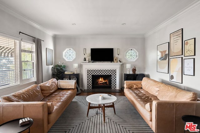 living room featuring a tiled fireplace and crown molding