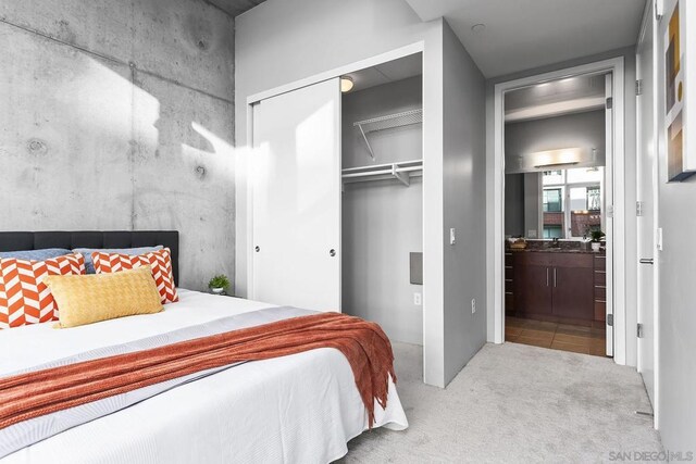 bedroom featuring light carpet and a closet