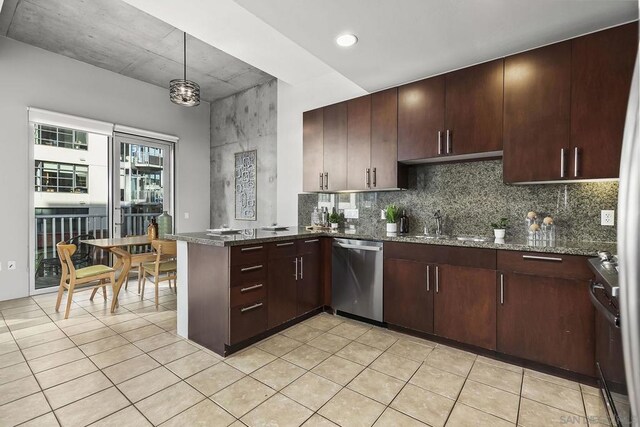 kitchen with decorative light fixtures, stainless steel appliances, decorative backsplash, stone countertops, and kitchen peninsula