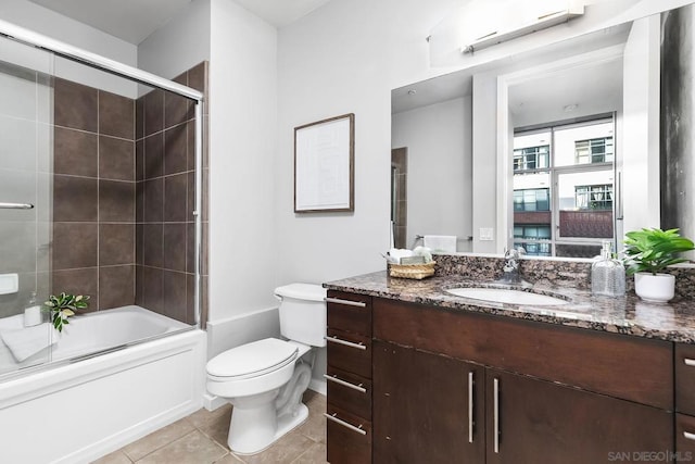 full bathroom with toilet, shower / bath combination with glass door, tile patterned floors, and vanity