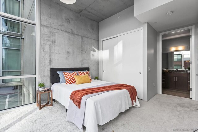 carpeted bedroom featuring a closet