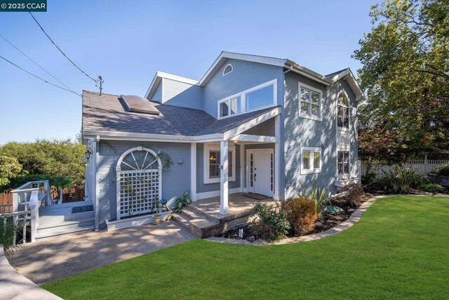 view of front of house with covered porch and a front yard