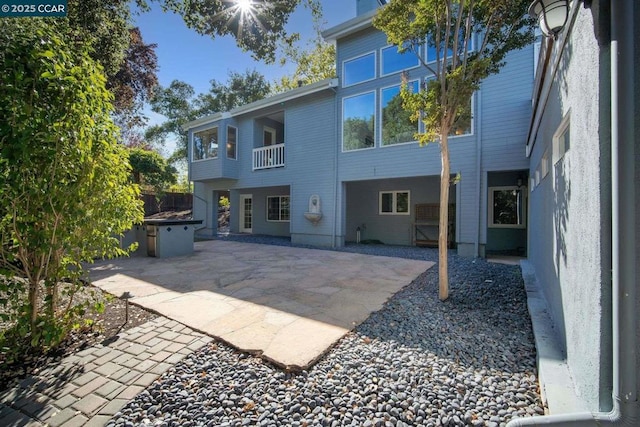 rear view of property featuring a patio area