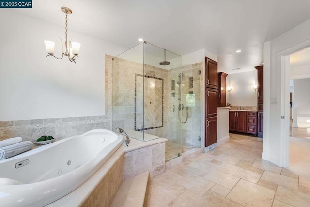 bathroom with independent shower and bath, a chandelier, and vanity