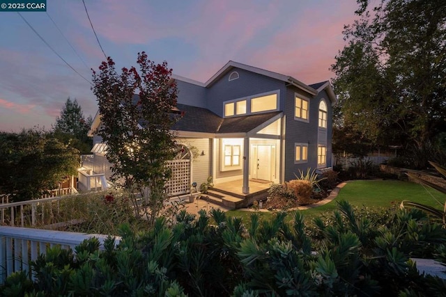 back house at dusk with a yard