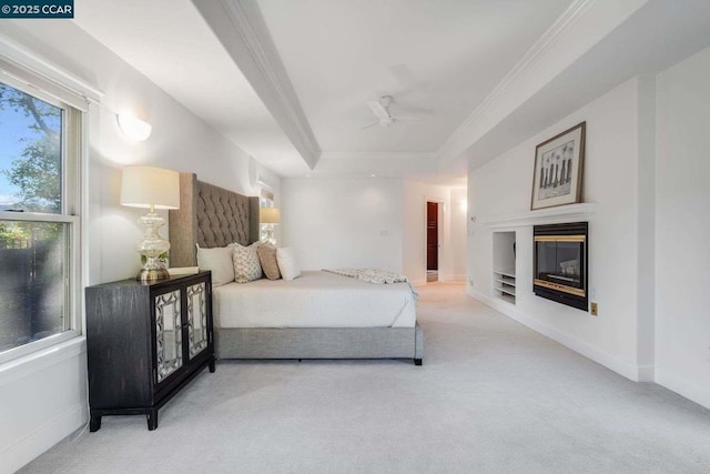 bedroom with carpet floors, a raised ceiling, ceiling fan, and ornamental molding