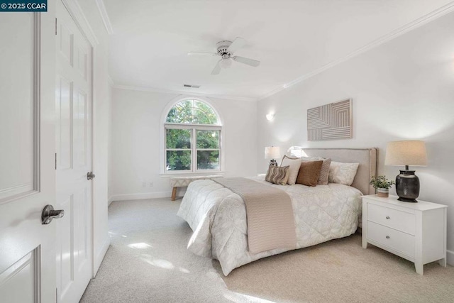 carpeted bedroom featuring ceiling fan and ornamental molding