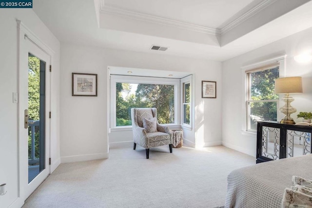 bedroom with crown molding, multiple windows, light colored carpet, a tray ceiling, and access to exterior