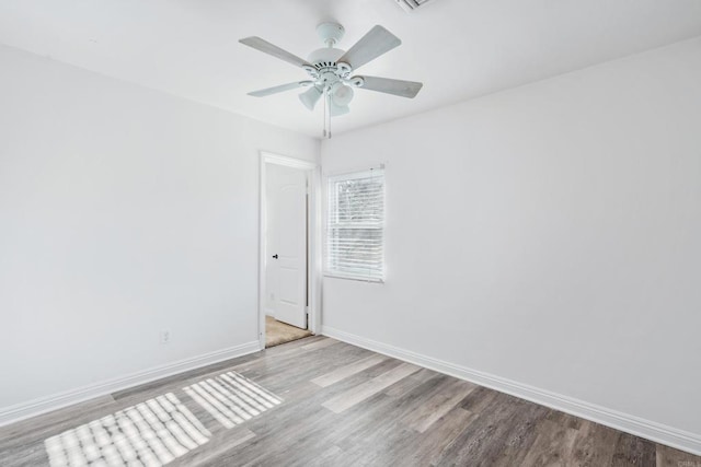 spare room featuring light wood-type flooring and ceiling fan