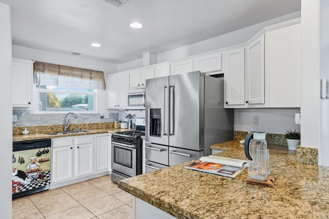 kitchen featuring light tile patterned floors, sink, white cabinets, kitchen peninsula, and stainless steel appliances