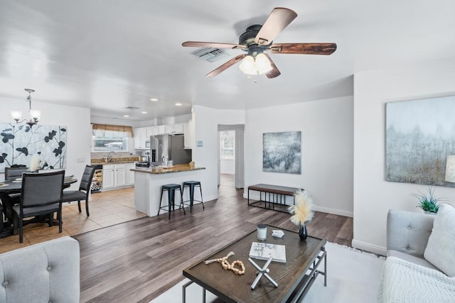 living room featuring sink, a wealth of natural light, and light hardwood / wood-style flooring