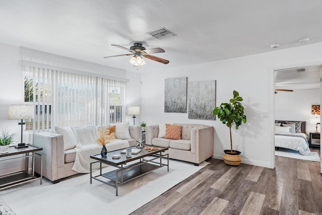 living room featuring ceiling fan and hardwood / wood-style floors