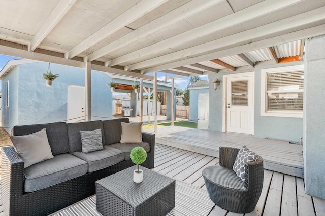 wooden terrace featuring an outdoor living space