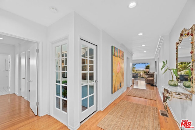 hallway with light hardwood / wood-style flooring