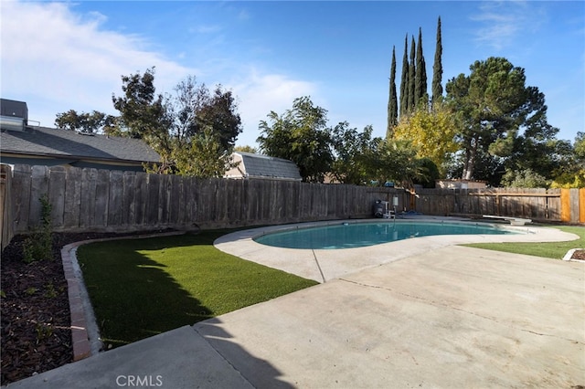 view of swimming pool featuring a yard, a diving board, a patio, and central air condition unit