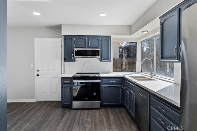 kitchen with dark wood-type flooring, stainless steel appliances, and sink