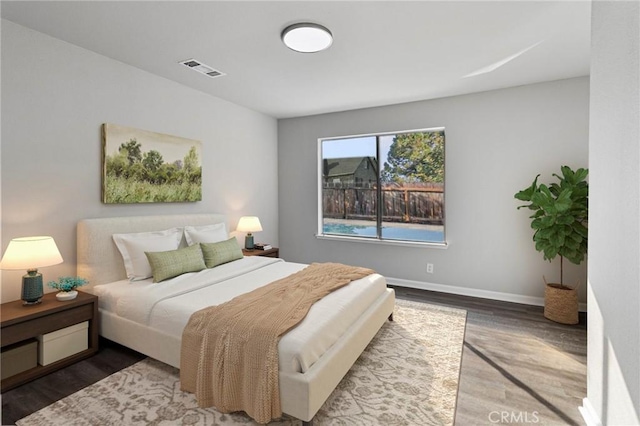 bedroom with dark wood-type flooring