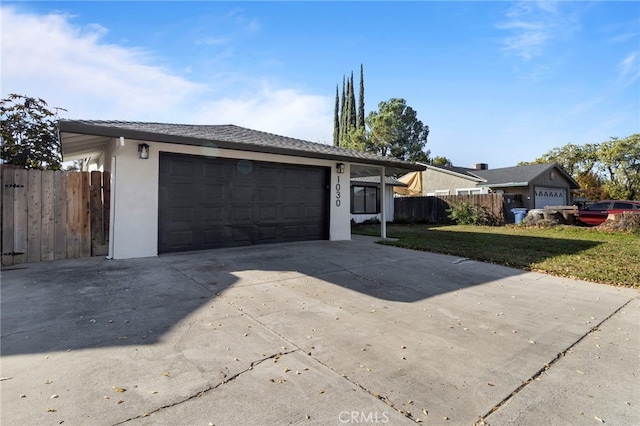 exterior space featuring a garage and a front lawn