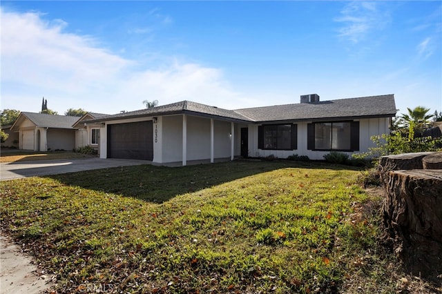 ranch-style house featuring a garage, central AC, and a front lawn