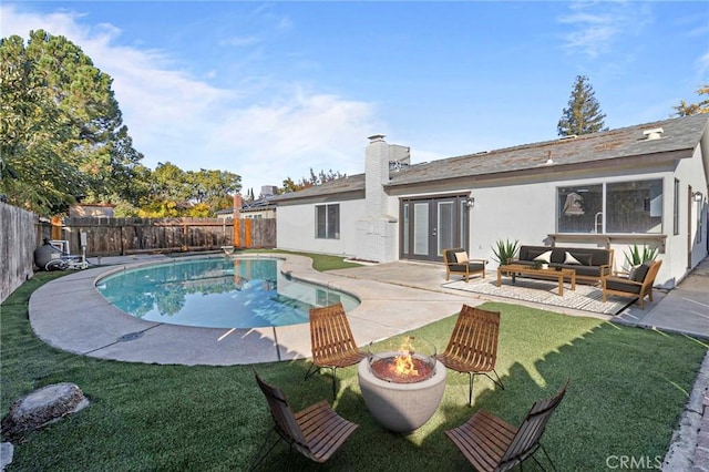 view of swimming pool with a yard, an outdoor living space with a fire pit, and a patio