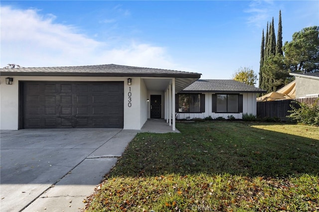 single story home featuring a garage and a front yard