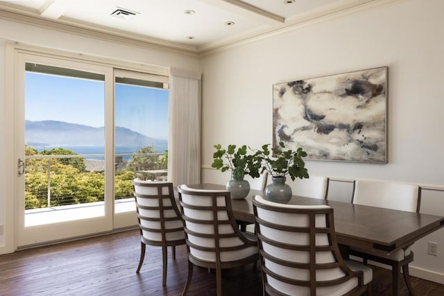 dining room featuring ornamental molding, dark hardwood / wood-style flooring, and a mountain view