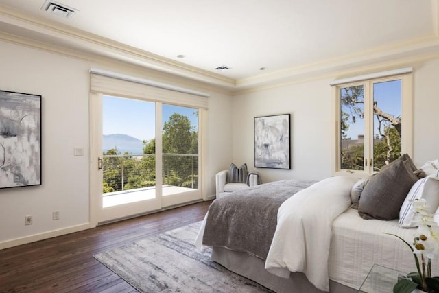 bedroom featuring dark wood-type flooring, ornamental molding, a mountain view, and access to outside