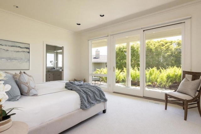 bedroom with multiple windows, access to exterior, ensuite bath, and ornamental molding