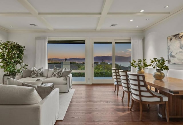 living room with coffered ceiling, beam ceiling, dark wood-type flooring, and crown molding