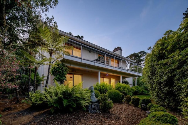 rear view of property with a balcony