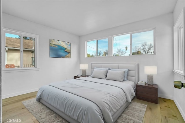 74357437 Balcom Ave, Reseda, CA 91335 - bedroom featuring multiple windows, light wood-style flooring, and baseboards