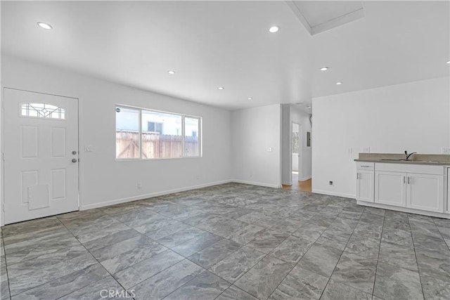 74357437 Balcom Ave, Reseda, CA 91335 - unfurnished living room with plenty of natural light, a sink, marble look tiles, recessed lighting, and baseboards