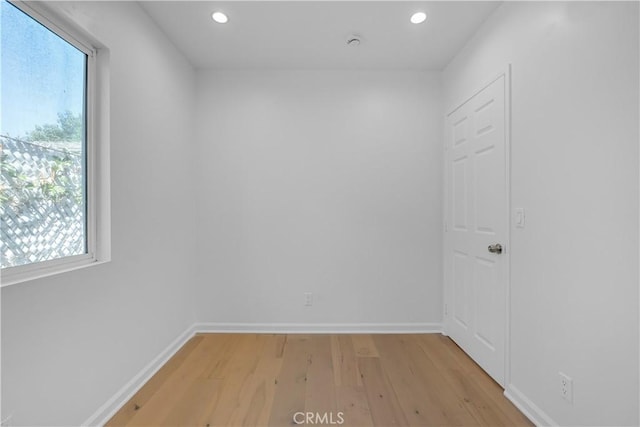 spare room with light hardwood / wood-style floors and a wealth of natural light