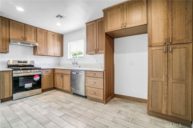 74357437 Balcom Ave, Reseda, CA 91335 - kitchen with appliances with stainless steel finishes, under cabinet range hood, light countertops, a sink, and recessed lighting