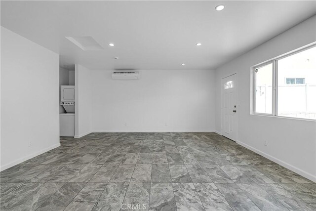 74357437 Balcom Ave, Reseda, CA 91335 - spare room featuring stacked washer and clothes dryer, recessed lighting, a wall mounted air conditioner, and baseboards
