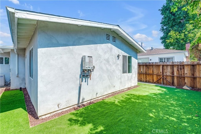 view of property exterior featuring central AC unit and a lawn