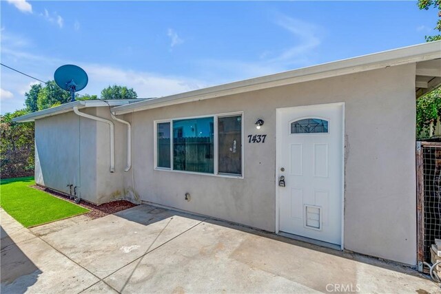 doorway to property with a patio area